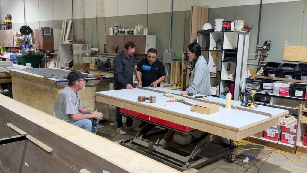 What Does a Commercial Millwork Company Do? Services, Project Process, and How to Choose the Right Partner 5 AF Johnson Millwork team reviewing commercial millwork fabrication project on shop floor in West Des Moines Iowa