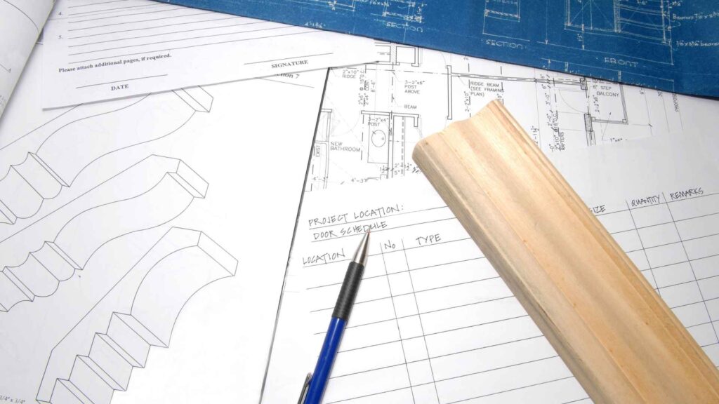 What Does an Architectural Millwork Company Do? Services, Process, and How to Choose the Right Partner 7 Architectural millwork shop drawings and blueprints with wood trim sample for commercial project planning